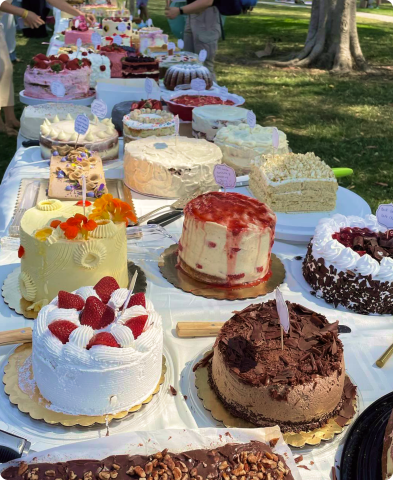 Several cakes on a table outdoors
