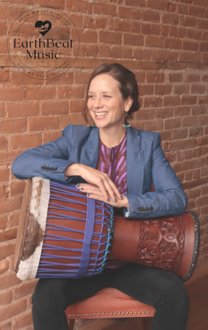 woman holding a west african drum